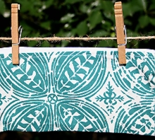 photo of closed zip pouch made by Homegrown Crafts out of a repurposed dinner napkin with blue batik print and white zipper