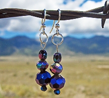 Kind of blue earrings with mountians in the background