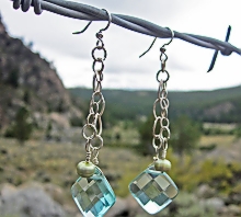 Blue Swell Drop earrings hanging on barbed wire