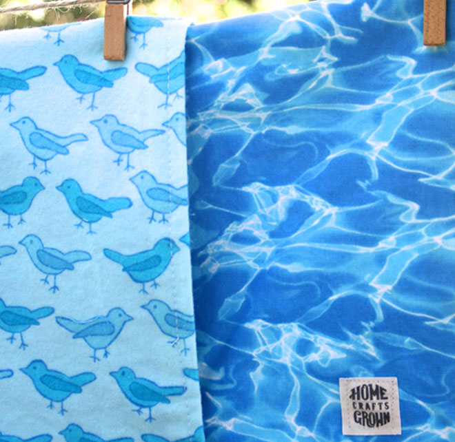 image of reversible toddler blanket made by Homegrown Crafts featuring blue bird print flannel and cotton print of blue pool water