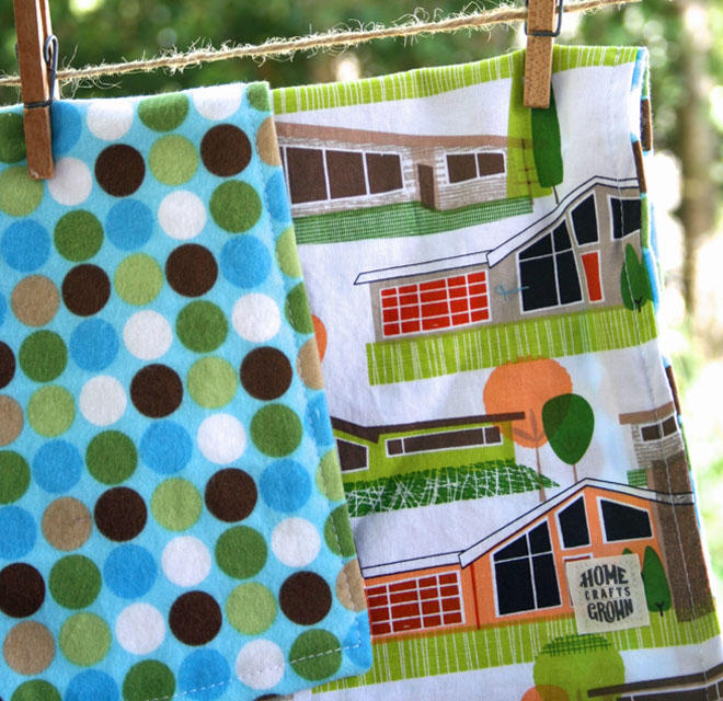photo of a fabric blanket made by Homegrown Crafts with multi colored blue polka dots and retro houses