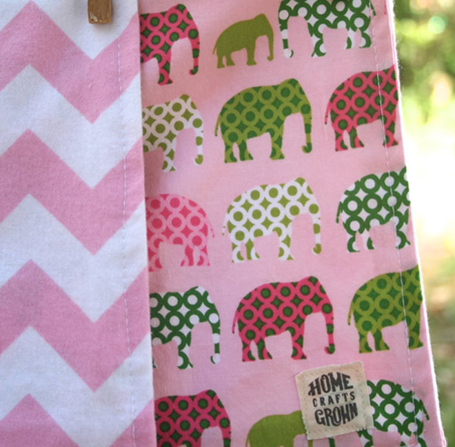 reversible toddler blanket made by Homegrown Crafts featuring flannel with pink and white chevron print and cotton multi colored elephant print