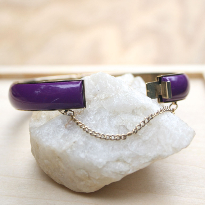 display of open clasp with safety chain on vintage acrylic bangle