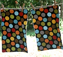 photo of two burp cloths made by Homegrown Crafts featuring multi colored large polka dot flannel
