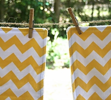 photo of two burp cloths made by Homegrown Crafts featuring a white and yellow chevron print
