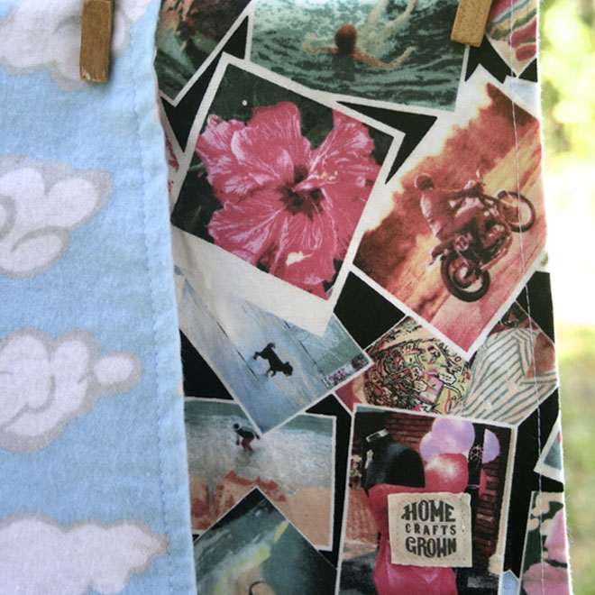 reversible infant blanket  made by Homegrown Crafts featuring flannel with blue and white cloud print and cotton multi colored print with old photos